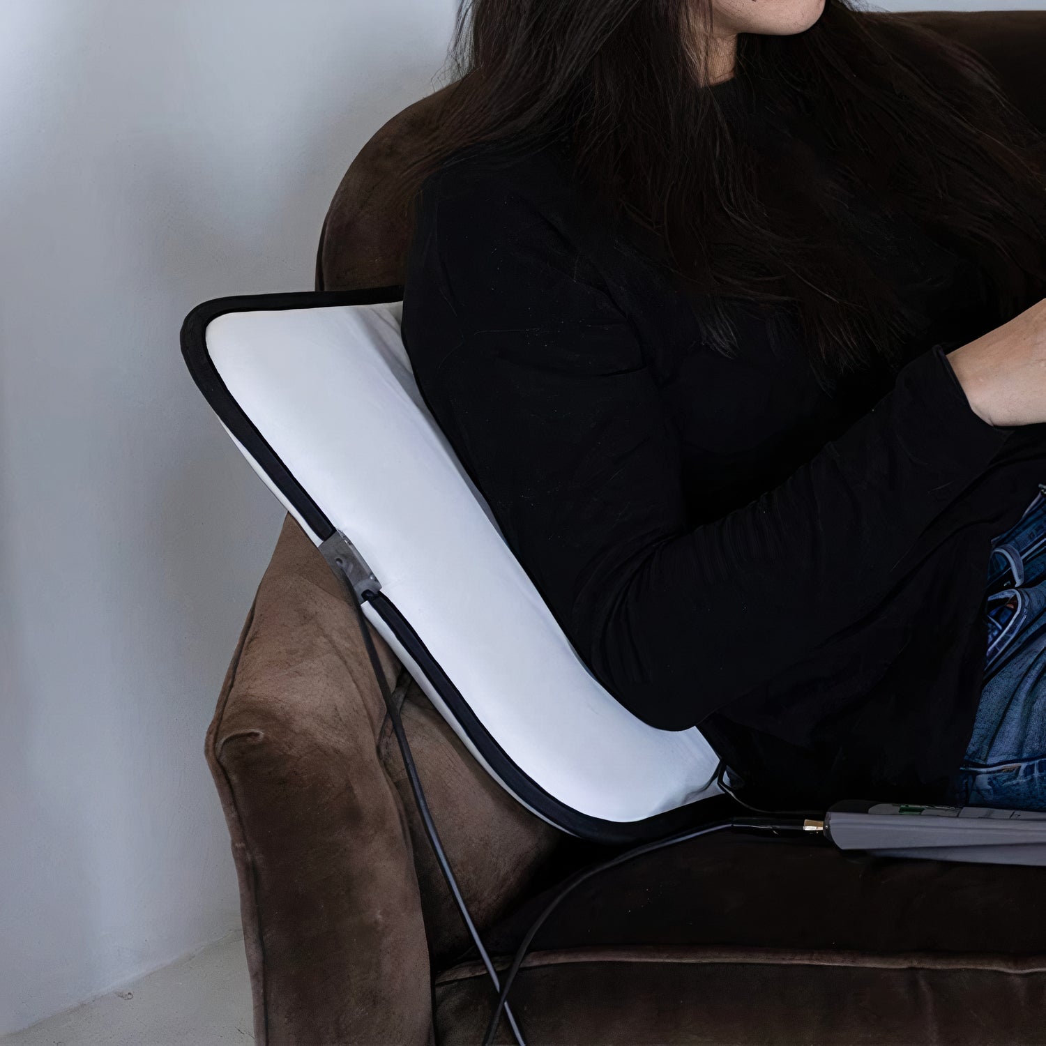 girl using a minimat pemf machine mat as a pllow in the uk