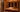 Warm wooden home infrared sauna with a towel, water bucket and carafe on the bench
