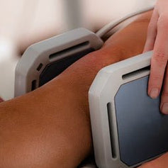 A leg and knee with a PEMF device wrapped around it so it can feel the benefit more directed and isolated.