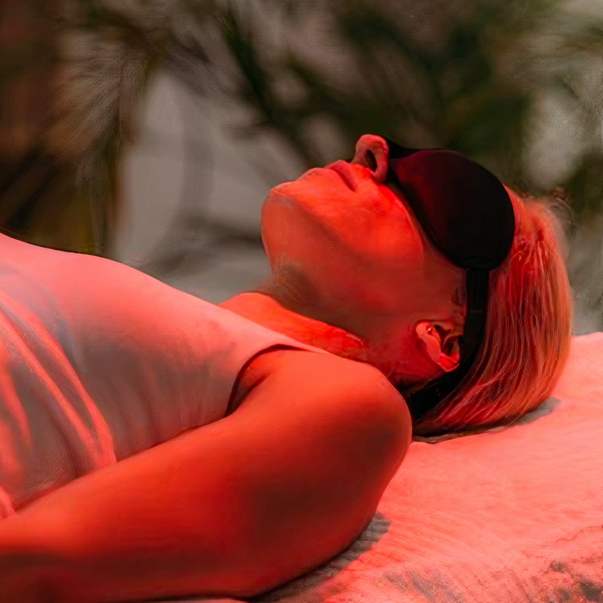 girl laying and relaxing under red light therapy light 