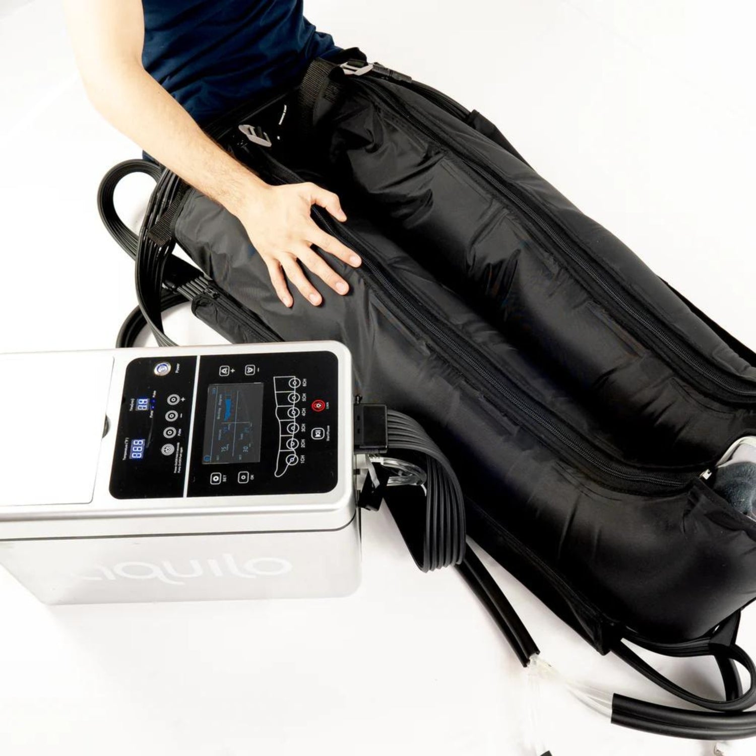 Man sitting with compression boots around his legs having ice pumped with the cryo machine
